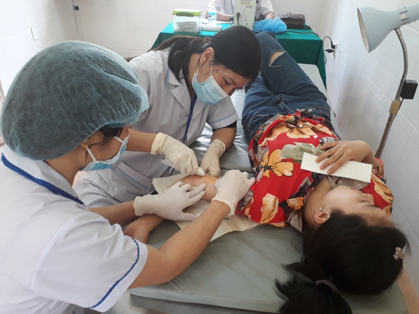 Cán bộ y tế thực hiện thủ thuật que cấy tránh thai tại xã Minh Tân
