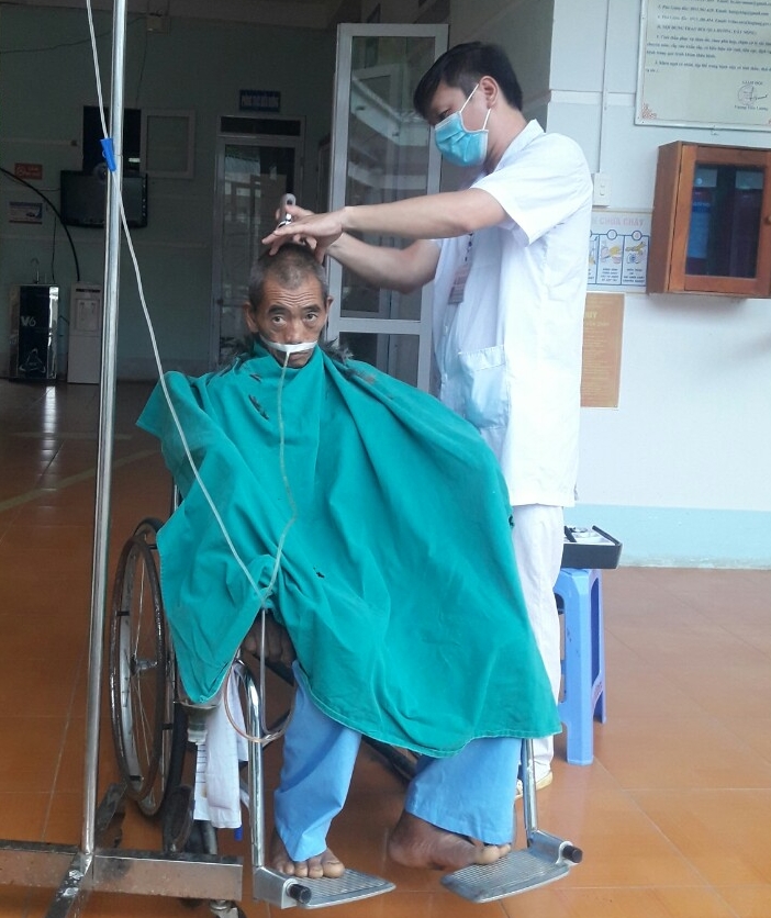 CNĐD Phạm Văn Đoàn đang cắt tóc và chăm sóc người bệnh
